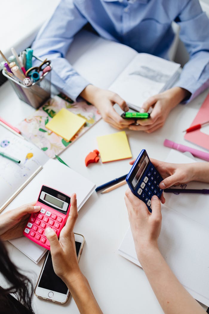 Home Group of children using calculators for math homework in a classroom.